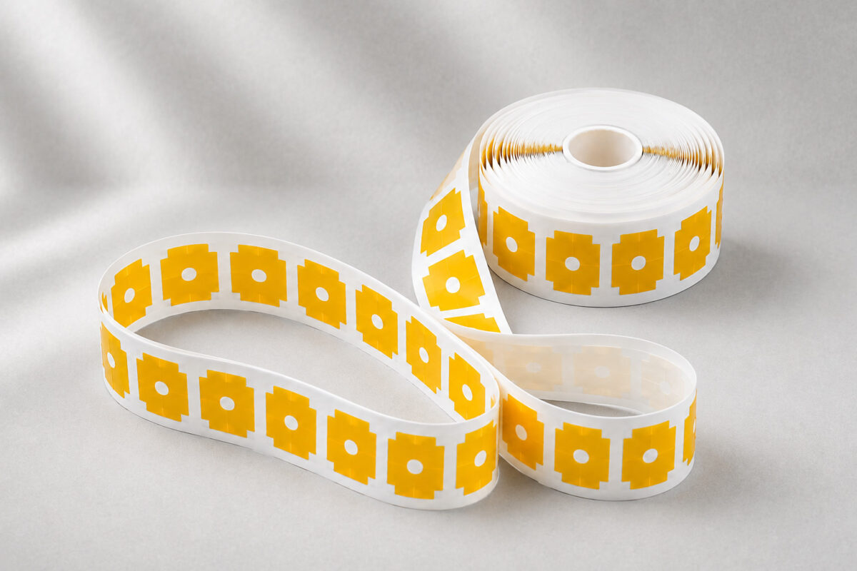 Die-cut pressure-sensitive adhesive tape parts on a roll